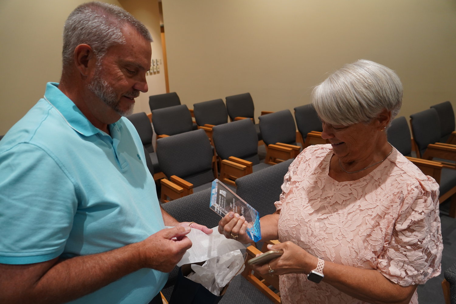 Carol Dutoi admires the 2022 Missouri Catholic Conference Citizen Recognition Award plaque that her husband, Dean Dutoi, received on Aug. 30.